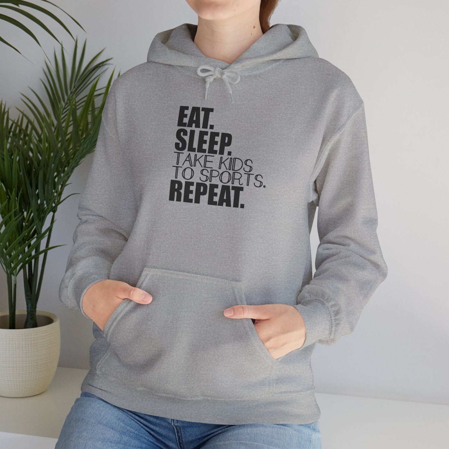 Unisex Heavy Blend™ Hooded Sweatshirt Reads, " Eat. Sleep. Take Kids to Sports. Repeat.